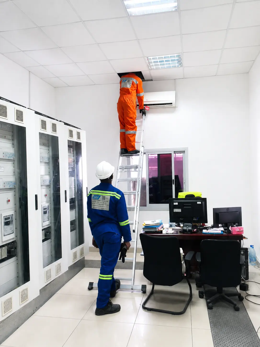 ISAS technicians installing detection and access control devices in a control room